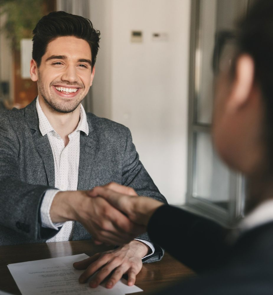 Smiling Manager Shaking Hands With Client